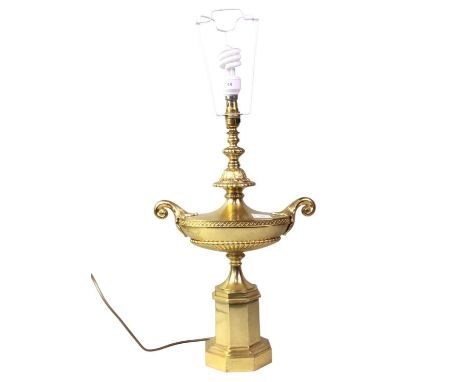 BRASS TABLE LAMP, wired for electricity, in the form of an Eastern style oil lamp, in gold finish, with urn like handles to t