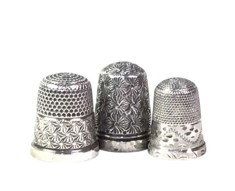 SEVEN SILVER THIMBLES, each engraved decoration