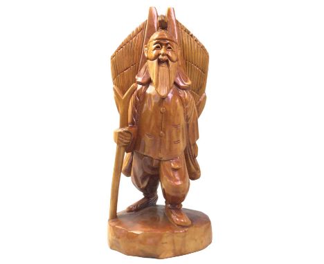 CHINESE WOODEN FIGURE, MID / LATE 20TH CENTURY modelled as a man with a walking stick carrying a basket44cm high