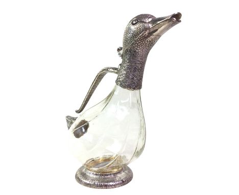 NOVELTY WHITE METAL AND CLEAR GLASS WINE DECANTER, modelled as a duck, on a raised circular base25.5cm high
