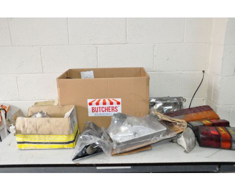 A BOX CONTAINING VINTAGE CAR PARTS including three 1994-2000 Transit Mk3 head lamps, a Cortina Mk5 Tail Light, a Cortina Mk 5