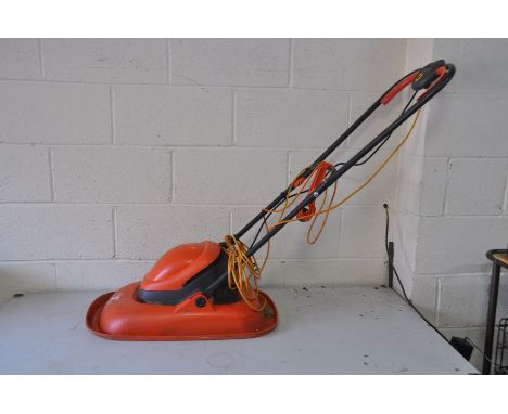 A FLYMO TURBO LITE 330 LAWN MOWER (PAT pass and working but cover to safety button is missing)