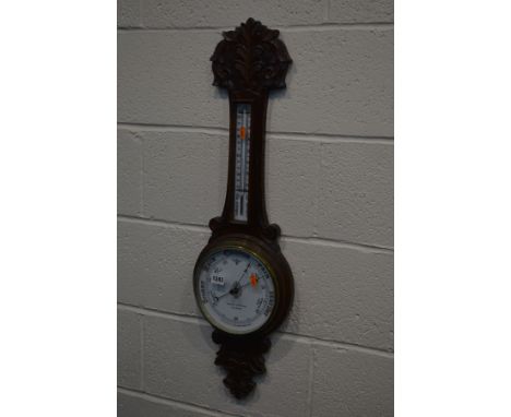 AN EDWARDIAN OAK ANEROID BAROMETER