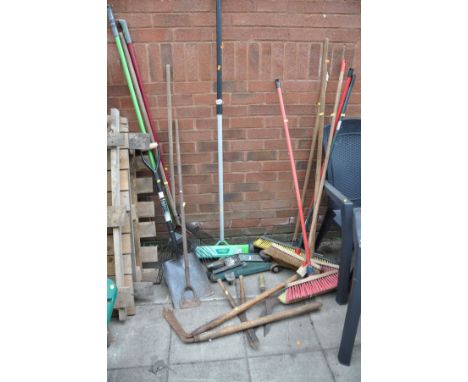 A PLASTIC WHEEL BARROW, a manual lawn aerator and various garden tools