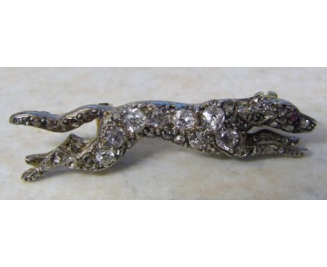Tested as 9ct gold (minimum) diamond greyhound brooch (approximate diamond total 0.4 ct) with ruby eye L 3.5 cm (safety chain