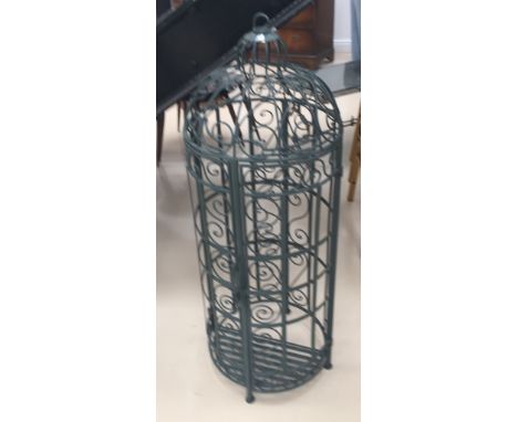 An ornate hinged wrought-iron garden arched planter
