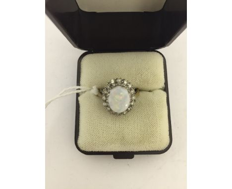 An 18ct opal and diamond dress ring CONDITION REPORT: Hallmarked18ct (rubbed) opal spreads as 2.5ct (not a doublet. Approx .2