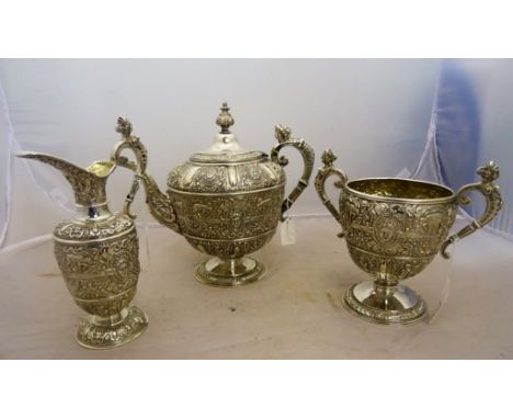 A Victorian silver three-piece tea service, by Steven Smith, London 1871, "Cellini" pattern, engraved with a crest and motto 