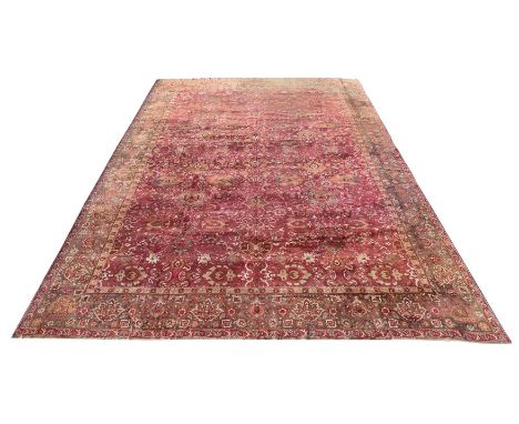 AN AGRA CARPETapproximately 682 x 446cmCondition Report: Some wear to carpet overall. One end of the carpet with heavy wear a