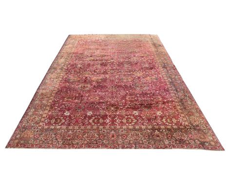 AN AGRA CARPETapproximately 682 x 446cmCondition Report: Some wear to carpet overall. One end of the carpet with heavy wear a