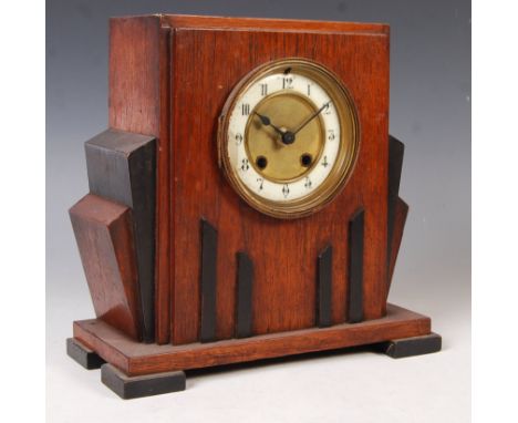 An early 20th century 1920's art deco oak mantel clock having stained and ebonised wood with fan shape and stepped block feet
