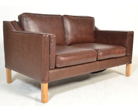 After Borge Mogensen - A late 20th century Danish retro vintage two seater sofa settee having a beech frame with chocolate br