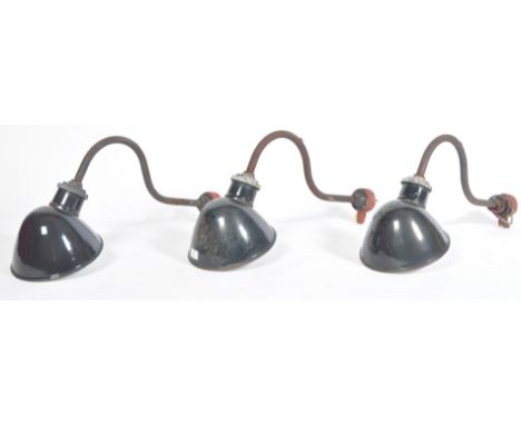 A set of three early 20th century 1940's vintage industrial exterior factory wall mounted lamps / lights having black enamel 