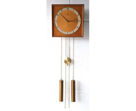 Junghans - A 1960's German retro vintage wall hanging teak wood pendulum clock having a brass square framed round face and Ar
