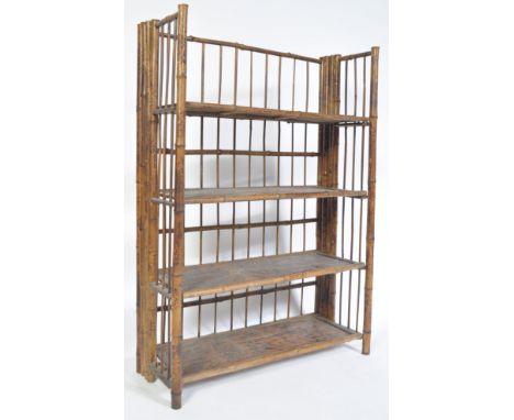 An early 20th century 1920's antique vintage bamboo four tier folding open faced display bookcase shelving unit having spindl