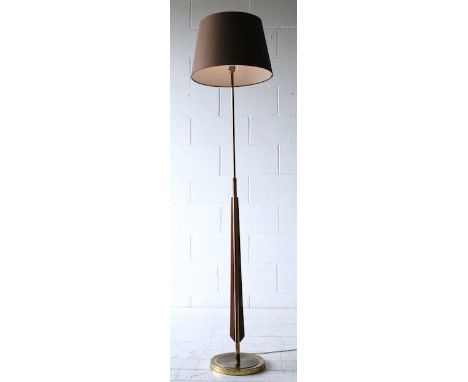 An original 1960's French teak and brass floor standing standard lamp having a round brass stepped base with central cylindri