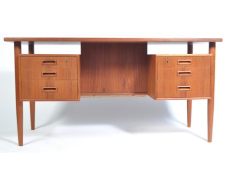 An original 1960's / 1970's Danish retro vintage teak wood twin pedestal double sided partners desk. The floating top raised 