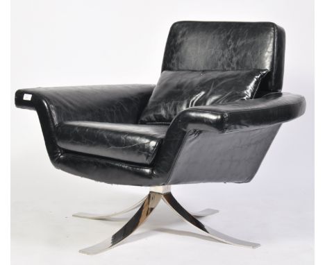 A late 20th century retro vintage black faux leather and chrome easy / lounge chair / armchair having a flared horseshoe shap