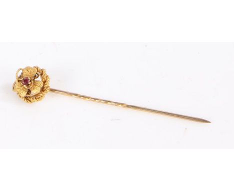 15 carat gold stick pin set with a central ruby to the head in the form of a flower, weight 1.6 grams&nbsp;