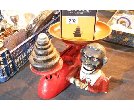 Vintage set of Lincoln kitchen scales with a set of graduated weights and an automaton money bank. Not available for in-house