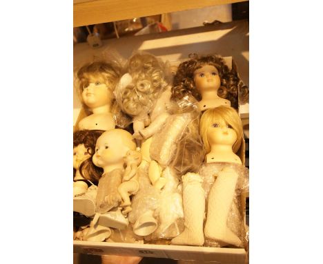 Tray of mainly ceramic dolls and parts. Not available for in-house P&amp;P. 