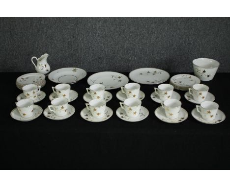 An early 20th century part porcelain tea set for twelve settings. Dia.23cm. (largest). 