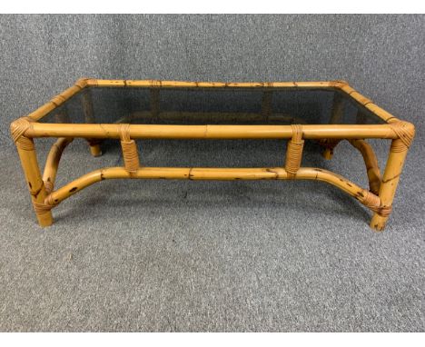 A vintage bamboo coffee table with smoked plate glass top. H.38 W.120 D.59cm 