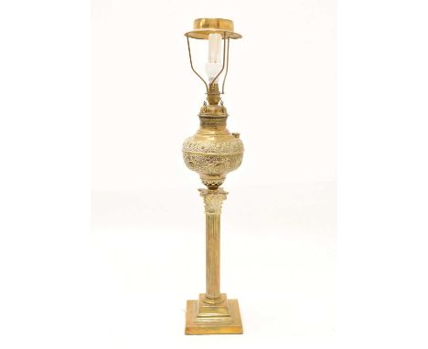 Gilt metal Corinthian column lamp, the foliate cast reservoir over reeded column raised on stepped base, (fitted for electric