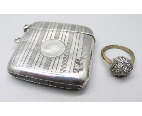 A silver vesta case, Birmingham 1922, and a cluster ring, O 