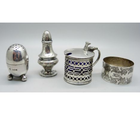 A pierced silver mustard with liner, Chester 1913, a Victorian silver napkin ring and two silver peppers, 96g 