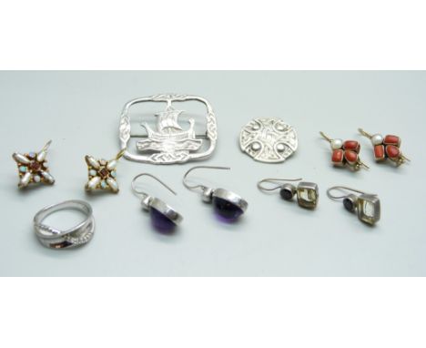 Two silver brooches, a silver ring and four pairs of earrings 