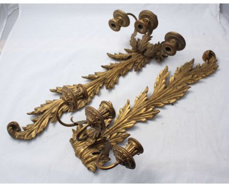 A pair of late 19th/early 20th century foliate-carved giltwood three-light candle sconces
