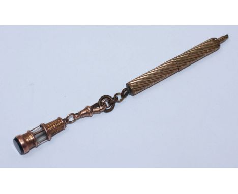 A 9ct gold fob seal modelled as a minor's/railway lamp, together with a yellow metal retracting pencil by Perry & Co.