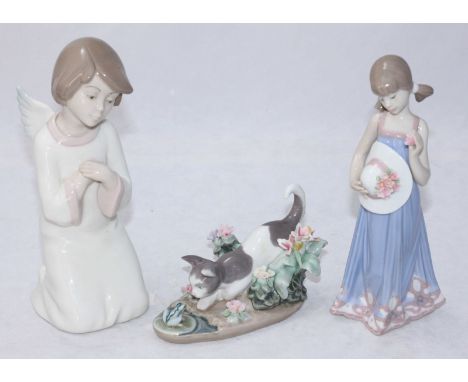 Two Lladro porcelain figures, one a girl with flowers, 'Spring Token 05604', the other a cat 'Kitty Confrontation 1.442' toge