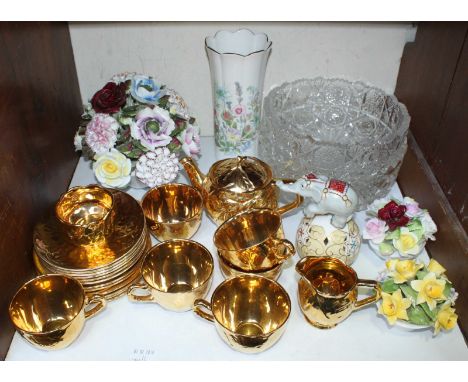 SECTION 18. A 21-piece gold coloured Royal Winton ceramic tea set, comprising of a teapot, cups, saucers and jugs etc. togeth