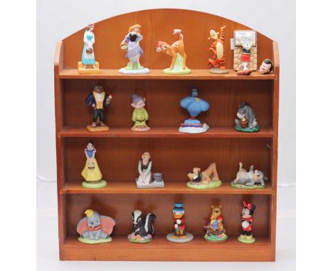 A collection of approximately eighteen ceramic Disney figures including Dumbo, Genie, Minnie Mouse etc. (one broken), approxi