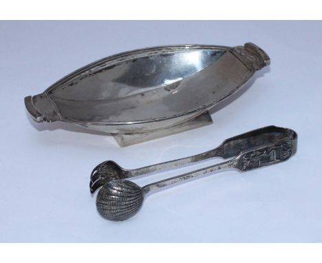 A pair of Export silver sugar tongs by Kwong Man Shing, the handles cast with figures and pagoda, 63g, together with a oval s