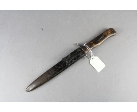 A WW2 German Nahkampfmesser or boot dagger. Having part double edged blade and held within steel scabbard with belt hook.