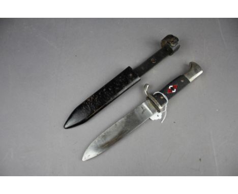 A German WW2 Hitler Youth dagger held within metal scabbard. HJ Badge to handle