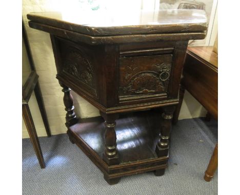 A small and rare oak credence table of triangular form, the hinged top supported by a single gate with turned balusters, the 