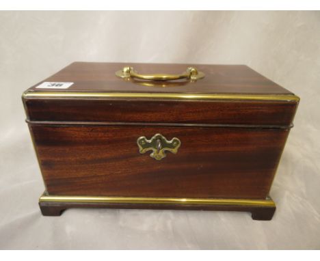 An early 19th century mahogany tea caddy with brass carry handle and fittings, opening to reveal two compartments
