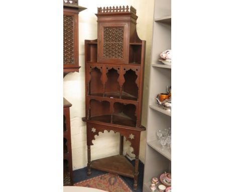 A matching Liberty & Co Moorish corner display cupboard with single door over two shelves, on a stand with lower shelf, ename