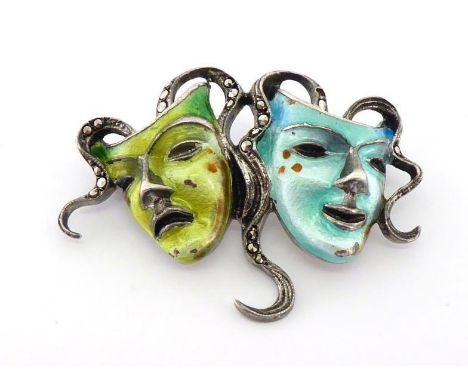 A 835 standard silver, enamel and marcasite brooch, representing the Theatre Masks, 4cm long, 8.4gms CONDITION: good overall 