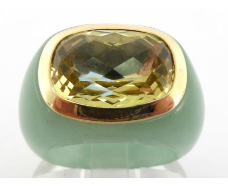 A citrine and jade ring, the central rectangular mixed cut stone 9.6 x 3.1mm, closed back, within a gold frame (stamped '14k'