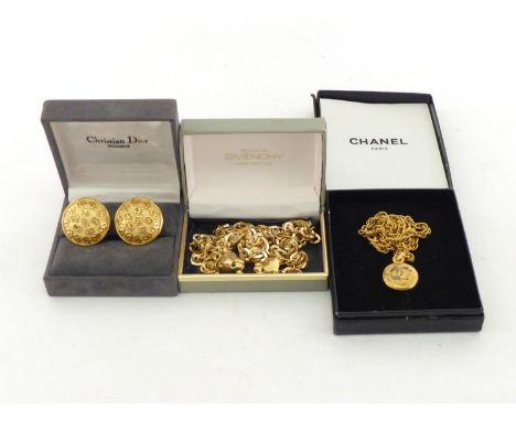 A group of designer costume jewellery, including a pair of Christian Dior ear clips, a Chanel pendant necklace (gilding rubbe