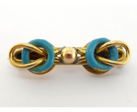 An early 20th century gold (tests 18 carat) and enamel bar brooch, of knot design, 2.8cm long, 3.5gms CONDITION: loss to the 