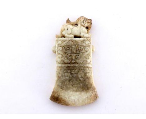 A Chinese jade carving pendant in the form of an axe, finely engraved Chinese stylized Taotie mask and leaves on both sides, 