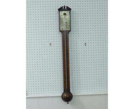 A Georgian stick barometer by Wisker, York, the mahogany case with herringbone veneer, broken pediment over the silvered pane