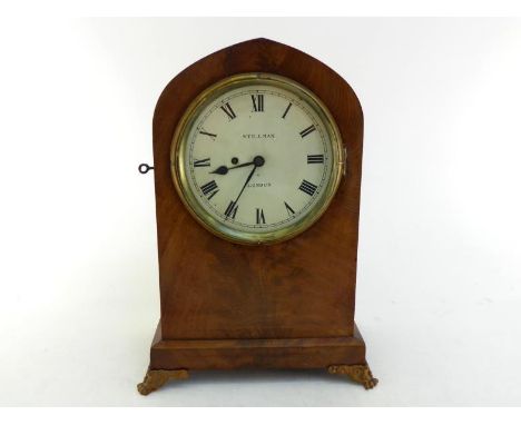 A 19th. century large flame mahogany veneered lancet cased mantel clock on gilt metal paw feet by Stillman, London, with fuse