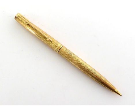 A 9 carat gold Parker retractable pencil, with jewel top and engine turned design, 25.9gms CONDITION:  working order 